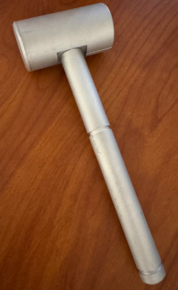 Manufactured hammer with a cylindrical head and stepped handle, shown assembled